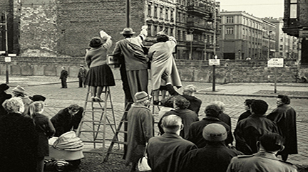 People from West Berlin looking behind the Berlin Wall